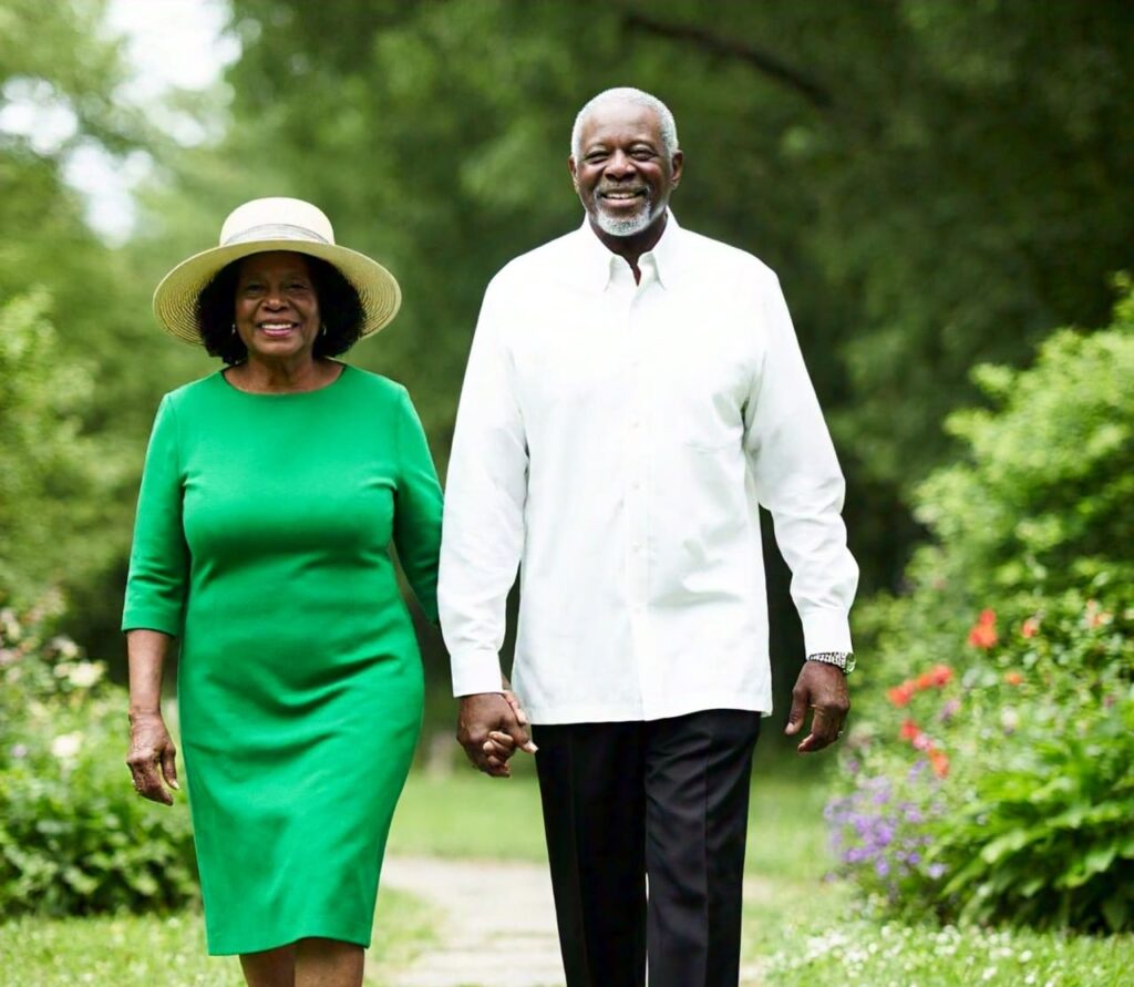 Senior couple walking briskly in a park, promoting exercise for brain health and Parkinson's prevention