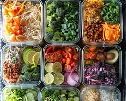 Colorful meal prep containers filled with healthy ingredients like fruits, vegetables, and whole grains.